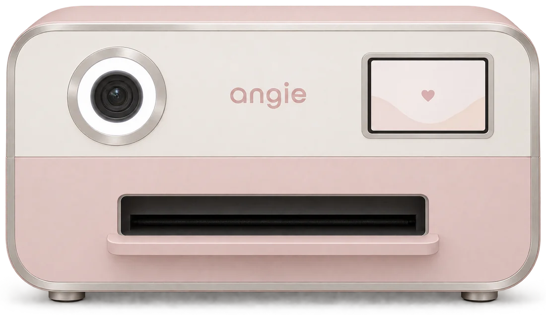 The Angie photobooth print unit, blush pink and white, printing a photo strip