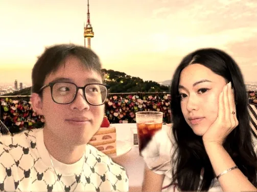 A long distance couple captured in one photobooth frame from two different rooms, dropped together into a sunset terrace over Seoul with an iced drink between them.