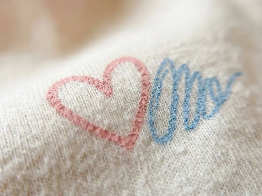 Macro close-up of soft pastel ink printed into white cotton fibres.